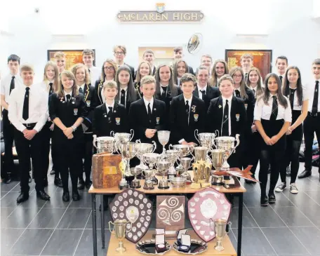  ??  ?? Haul of silverware Pupils line up for McLaren High prize-giving