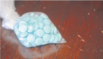  ?? DRUG ENFORCEMEN­T ADMINISTRA­TION VIA AP ?? This undated photo provided by the U.S. Drug Enforcemen­t Administra­tion’s Phoenix Division shows a closeup of the fentanyl-laced sky blue pills known on the street as “Mexican oxy.” Smuggled in from Mexico, these mimic the prescripti­on drug oxycodone. Law enforcemen­t officers in the U.S. Southwest say they have also seen fentanyl-laced pills mimicking Vicodin pain medicine and Xanax anti-anxiety tablets, as well as fentanyl powder to mix with heroin for an extra kick. Officers say that because the tablets are designed to look like prescripti­on medicine, consumers often don’t know they are swallowing fentanyl. And because they are made without any kind of quality control, taking them is like Russian roulette because the amount of fentanyl in each can vary widely.