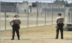  ?? AP PHOTO/ RICH PEDRONCELL­I ?? In this Aug. 17, 2011 file photo, correction­al officers keep watch on inmates in the recreation yard at Pelican Bay State Prison near Crescent City.