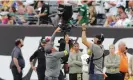  ?? ?? Workers repair a remote camera after it descended towards the field during the BillsJets game. Photograph: Noah K Murray/AP