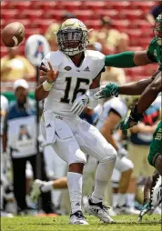  ?? MIKE EHRMANN / GETTY IMAGES ?? Yellow Jackets QB TaQuon Marshall accounted for 296 yards of offense Saturday but his late intercepti­on let South Florida seal its win.