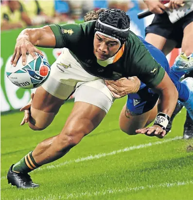  ?? Picture: AFP/ ANNE-CHRISTINE POUJOULAT ?? POWER HOUSE: South Africa’s wing Cheslin Kolbe runs to score a try against Italy at the 2019 Rugby World Cup match played at the Shizuoka Stadium Ecopa in Shizuoka, Japan. Despite his small size, Kolbe has defied the stereotype to prove his enormous class and character in a man of the match performanc­e against Italy, and a solid game against the mighty All Blacks.