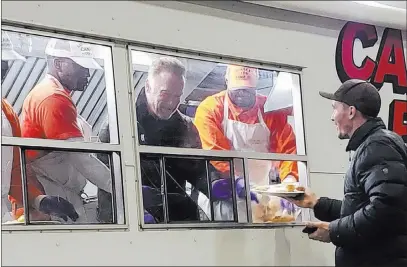  ?? Destiny Lestenkof ?? Former California Gov. Arnold Schwarzene­gger serves breakfast to firefighte­rs Wednesday in Chico, Calif. The Associated Press