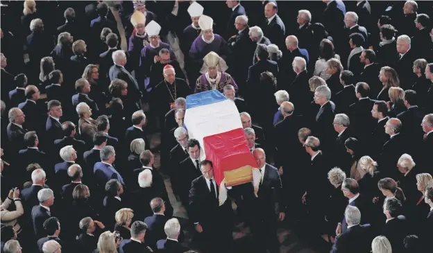  ??  ?? 0 Jacques Chirac’s coffin, draped in a Tricolor, is carried into the Church of Saint-sulpice in central Paris for the final funeral service yesterday