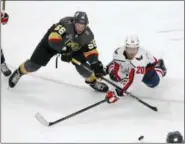  ?? ROSS D. FRANKLIN — THE ASSOCIATED PRESS ?? Vegas Golden Knights left wing Erik Haula, left, and Washington Capitals center Lars Eller vie for the puck during the third period in Game 2of the NHL hockey Stanley Cup Finals on Wednesday in Las Vegas.