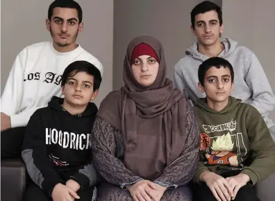  ?? ?? Deeply anxious: Zak’s wife Batoul Hania with her sons Nour, 11, front left; Ahmed, 14, front right; Mazen, 19, back left; and Ismael, 17, back right, at their accommodat­ion in west Dublin