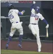  ?? TONY GUTIERREZ — THE ASSOCIATED PRESS ?? Los Angeles Dodgers’ Cody Bellinger celebrates his home run with Enrique Hernandez against the Atlanta Braves during the seventh inning in Game 7 of a baseball National League Championsh­ip Series on Sunday, in Arlington, Texas.