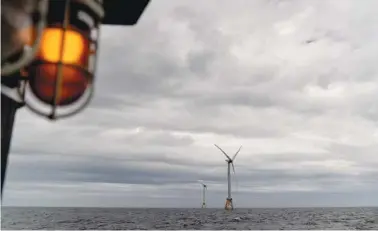  ?? AP PHOTO/DAVID GOLDMAN ?? Two turbines of America’s first offshore wind farm, owned by the Danish company Orsted are seen in October from a tour boat off the coast of Block Island, R.I.