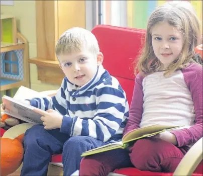  ?? MITCH MACDONALD/THE GUARDIAN ?? Siblings Cooper, left, and Jorja Bourque read some books during the Family Literacy Day celebratio­n at Montague Rotary Library on Saturday. This year’s event encouraged families to read and learn together, with the two Bourque siblings attending the...