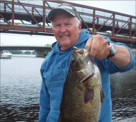  ?? ?? Leo Maloney catching a smallmouth bass on the St. Lawrence River.