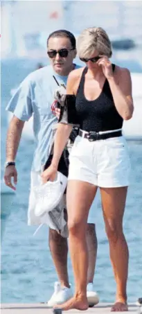  ??  ?? Carefree: Diana and Dodi Fayed, walk on a pontoon in the French Riviera resort of St Tropez, days before they were both killed in a car accident