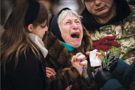  ?? (AP/Emilio Morenatti) ?? Nina Nikiforova, 80, cries Feb. 11 outside a church after attending the funeral of her son Oleg Kunynets, a Ukrainian military serviceman who was killed in the east of the country, in Kyiv, Ukraine.