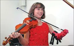  ??  ?? Ten-year-old Isabella Nicola Cabrera smiles after playing her violin with her new prosthetic at the engineerin­g department of George Mason University on Thursday in Fairfax, Va. "Oh my gosh, that's so much better," Isabella said as she tried out the...