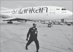  ?? AGENCIES ?? Anti-government demonstrat­ors scuffle with police during a protest in Colombo, Sri Lanka, on Monday and a file photo of the Sri Lankan airlines aircraft.