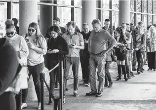  ?? Photos by Brett Coomer / Staff photograph­er ?? Early voters line up outside the polling place at the Metropolit­an Multi-Service Center in Houston on Friday, the final day of early voting, before the Super Tuesday primary election.