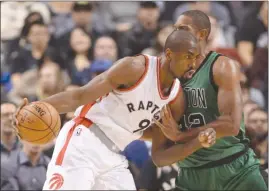  ?? The Canadian Press ?? Toronto Raptors newcomer Serge Ibaka, left, tries to work against Al Horford of the Boston Celtics during NBA action in Toronto on Friday. The Raptors won 107-97.