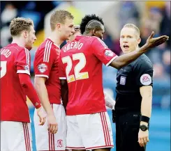  ??  ?? SURROUNDED: Referee Stephen Martin waves away Boro protests