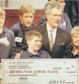  ?? SHAYNA BRENNAN/ASSOCIATED PRESS ?? Alex Trebek moderated the National Geography Bee for a number of years, too. Here he’s with Michael Ring, who was awarded $15,000 after finishing second in 1993.