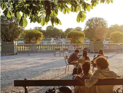  ?? Ed Alcock / New York Times ?? Visitors bask in the sun at the Luxembourg Gardens in Paris. Paris is a city where you can take a luxury vacation without breaking the bank.