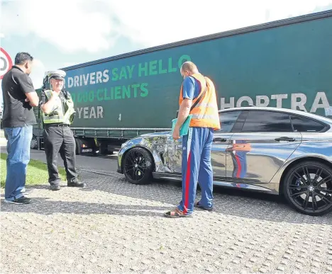  ??  ?? MOTORISTS faced delays today after crash between a lorry and a car.
Police were called after a collision involving a lorry from Lithuania and a mirror-effect BMW 4 Series on Dundee’s Kingsway.
The crash happened around 8.45am at the Scott Fyfe...