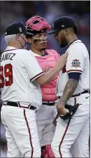  ?? BEN MARGOT — THE ASSOCIATED PRESS ?? Braves pitcher Huascar Ynoa, right, speaks with pitching coach Rick Kranitz (39) and catcher William Contreras during the first inning Sunday night.