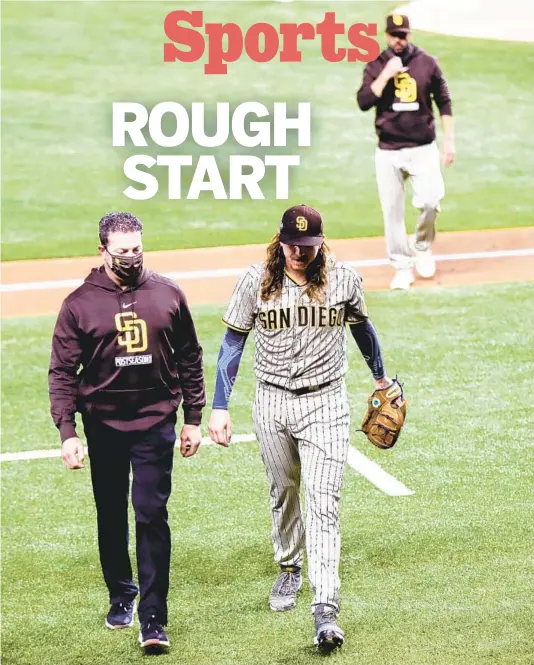  ?? K.C. ALFRED U-T PHOTOS ?? Injured Padres pitcher Mike Clevinger (center) is pulled from the game by manager Jayce Tingler (right) in the second inning Tuesday night against the Dodgers.