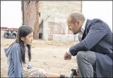  ?? LIONSGATE ?? Haunted, hunted Luke Wright (Jason Statham) accepts the challenge to keep Mei (Catherine Chan) “Safe” from mobsters in this hard-driving action film.