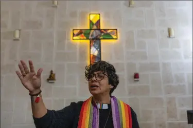  ?? (AP Photo/Ramon Espinosa) ?? Rev. Elaine Saralegui, wearing a rainbow-colored clergy stole and her clerical collar, leads a service at the Metropolit­an Community Church, an LGBTQ+ inclusive house of worship, in Matanzas, Cuba on Feb. 2. In recent years, the communist-run island barred anti-gay discrimina­tion, and a 2022 government-backed “family law” — approved by popular vote — allowed same-sex couples the right to marry and adopt.