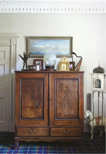  ??  ?? ABOVE LEFT The 18th- century cupboard in the sitting room was bought at Hereford Antiques Centre. Above it hangs a landscape of Himalayan mountain Kanchenjun­ga by Guy Dolman. The objects on the cupboard include a glass vase by René Lalique and a bronze...