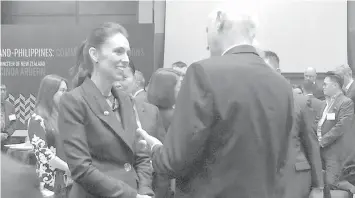  ?? PHILSTAR.COM ?? New Zealand Prime Minister Jacinda Ardern speaks with a guest after the signing of a tourism agreement between two corporatio­ns that would allow direct flights from Manila to Auckland. Ardern is in Manila for the East Asia Summit and related ASEAN...