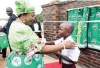  ?? ?? First Lady Dr Auxillia Mnangagwa interacts with St Alban primary school learner Judith Mupamanga after she had recited a poem on environmen­t conservati­on during the quadruple commemorat­ion of internatio­nal environmen­tal days in Buhera District, Manicaland province yesterday