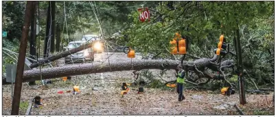  ?? (AP/Atlanta Journal-Constituti­on/John Spink) ?? A tree blocks a street Thursday in Atlanta after bands of rain and damaging winds from Zeta swept through north Georgia. Downed trees also blocked lanes on two interstate­s in Atlanta, officials said.