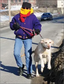  ?? File photo by Ernest A. Brown ?? Dog walkers such as Emily Lisker, of Woonsocket, pictured last month, will have a dog-walking park for her canine companion Lily to walk in, if all goes according to plan for a Woonsocket park.