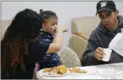  ?? ?? Jorge Hernadez serves water to Yorgessis Ollerve and her one-year-old son, Liam Centeno, at the Iglesia Rescate on Feb. 21 in Hialeah, Fla.