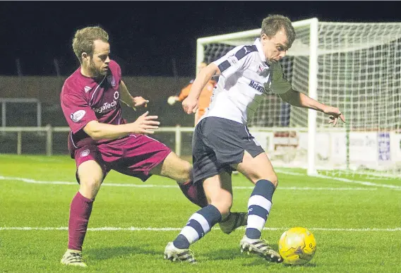  ??  ?? Dundee’s Paul McGowan slips past Arbroath’s Colin Hamilton during last night’s friendly at Gayfield.