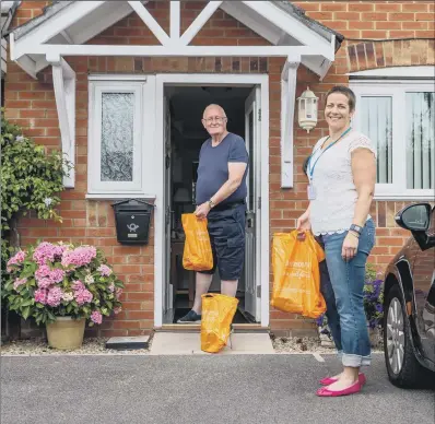  ?? PICTURE: JAMES HARDISTY ?? LIFELINE: Lucy Currie delivers shopping in Northaller­ton to neighbour Paul West, who has been isolating in the pandemic.