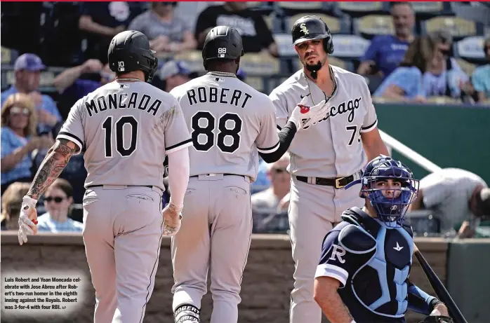  ?? AP ?? Luis Robert and Yoan Moncada celebrate with Jose Abreu after Robert’s two-run homer in the eighth inning against the Royals. Robert was 3-for-4 with four RBI.