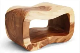  ?? HOMEGOODS VIA AP ?? A HomeGoods side table of carved olive wood showcases the curvy grain.