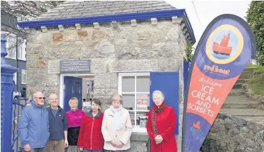  ??  ?? Red Boat owners Tony and Lyn Green (in doorway) with members of Menai Heritage and the Menai Bridge Civic Society.