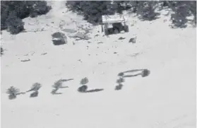  ?? PHOTO:AFP ?? This image from the U.S. Coast Guard shows a ‘Help’ sign on the beach made with palm leaves by three mariners stranded on Pikelot Atoll, Yap State, in the Federated States of Micronesia.