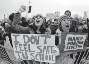  ?? Nam Y. Huh, The Associated Press ?? Demonstrat­ors hold signs and shout during a March for Our Lives rally in Chicago on Saturday.