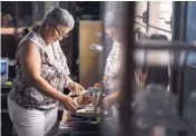  ?? CARLOS GIUSTI/ASSOCIATED PRESS ?? Nerybelle Perez looks at photos of her father, Efrain Perez, who died in an ambulance after being turned away from a hospital after Hurricane Maria.