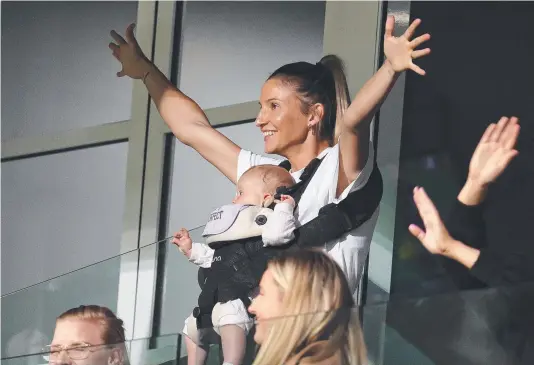 ?? Picture: Michael Klein ?? Profession­al netballer and new mum Kim Ravaillion, with Georgie, cheers on her partner, AFL player Adam Treloar.