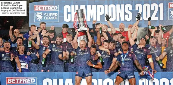  ?? MARTIN RICKETT/PA WIRE ?? St Helens’ James Roby lifts the Super League Grand Final trophy at Old Trafford