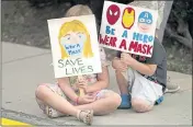  ?? RICK BOWMER — THE ASSOCIATED PRESS ?? Lucie Phillips, 6, and her brother David Phillips, 3, join parents and students during a rally calling for a mask mandate Friday at the Utah State School Board Office in Salt Lake City.