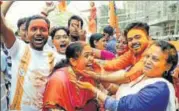  ?? REUTERS ?? BJP supporters apply colour as they celebrate the party’s win in Agartala on Saturday.