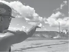  ?? Associated Press ?? ■ Brian Weekly, a contractor at West Virginia’s Grant Town coal-fired power plant, gestures toward the small facility’s smokestack Aug. 23 in Grant Town, W.Va. Weekly says opponents of the coal industry are behind warnings of health risks from smokestack emissions under the Trump administra­tion’s plan.