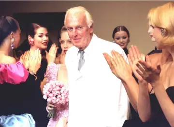  ??  ?? French fashion designer Hubert de Givenchy is applauded by the models after he presented his last High Fashion collection Autumn/Winter 1995 in Paris July 11. • (Below, right) In this file photo taken on October 21, 1991 Givenchy (Left) and American...