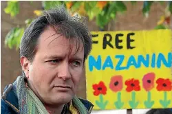  ?? PHOTO: REUTERS ?? Richard Ratcliffe talks to demonstrat­ors after following a march in London in support of his wife, Nazanin Zaghari-ratcliffe, the British-iranian mother who is in jail in Iran. There is now a risk her five-year prison term will be lengthened.