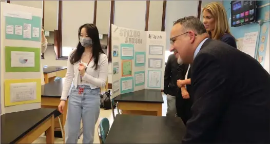  ?? JULIA MALAKIE PHOTOS / LOWELL SUN ?? ON DISPLAY: U.S. Secretary of Education Miguel Cardona visits Lowell High School with U.S. Rep. Lori Trahan, and hears from senior Michele Pham about her project in Intro to Engineerin­g class through Middlesex Community College.